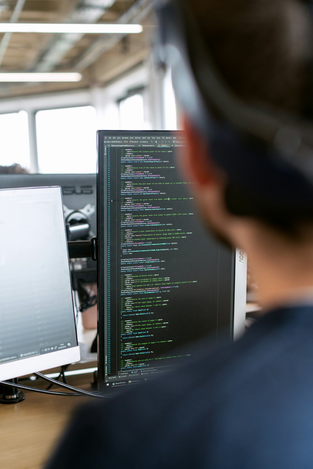 Developer reviewing code on a monitor